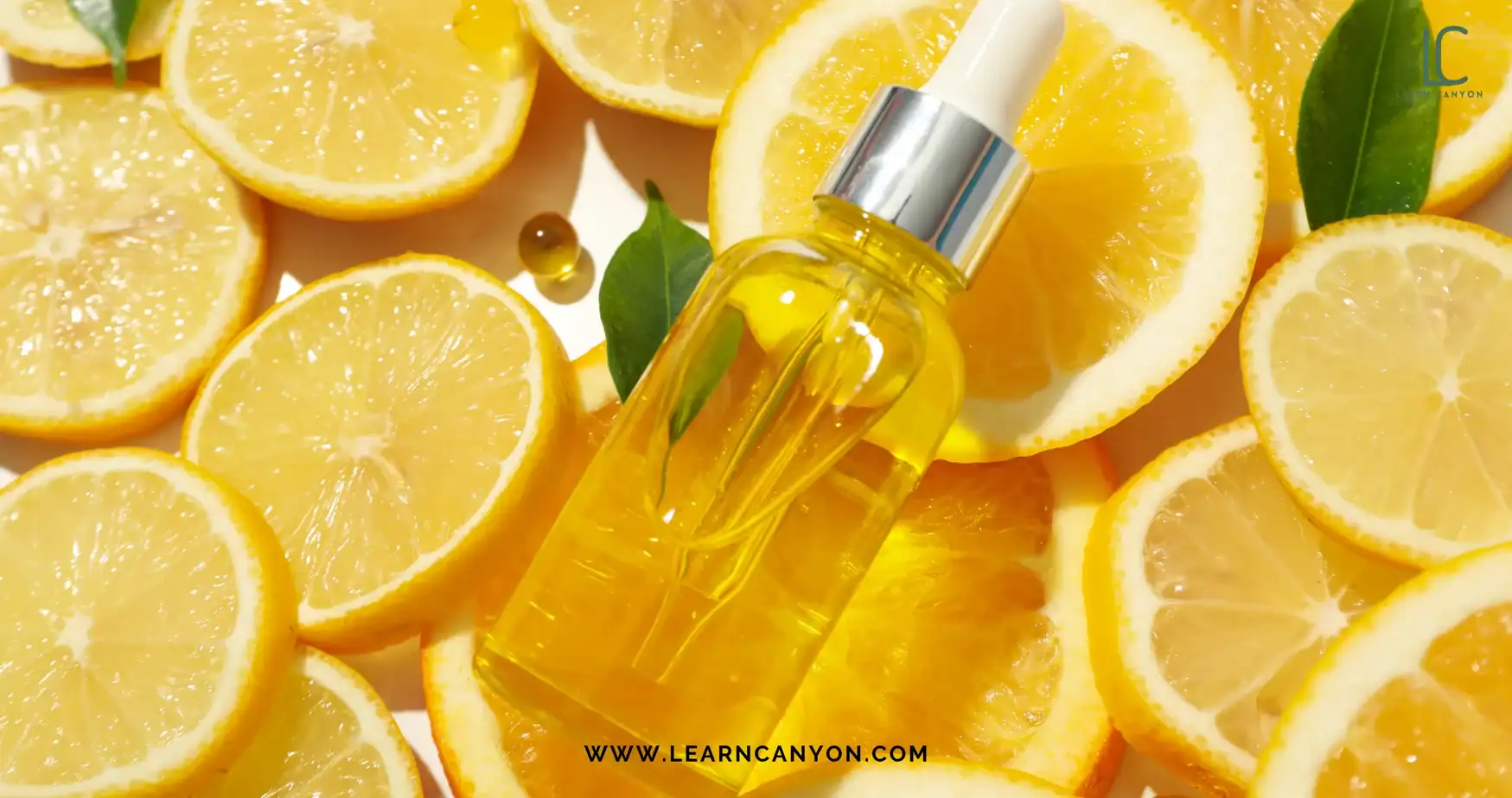 Organic vitamin C-inspired glow serum dropper bottle surrounded by fresh lemon slices