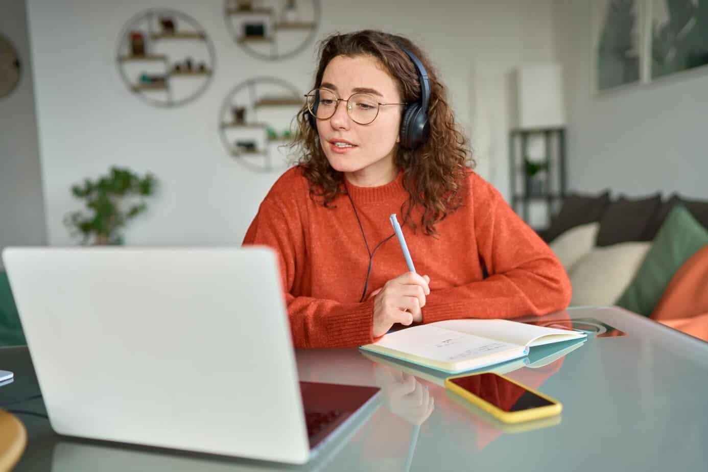 Student studying self-paced online lessons on a laptop at home