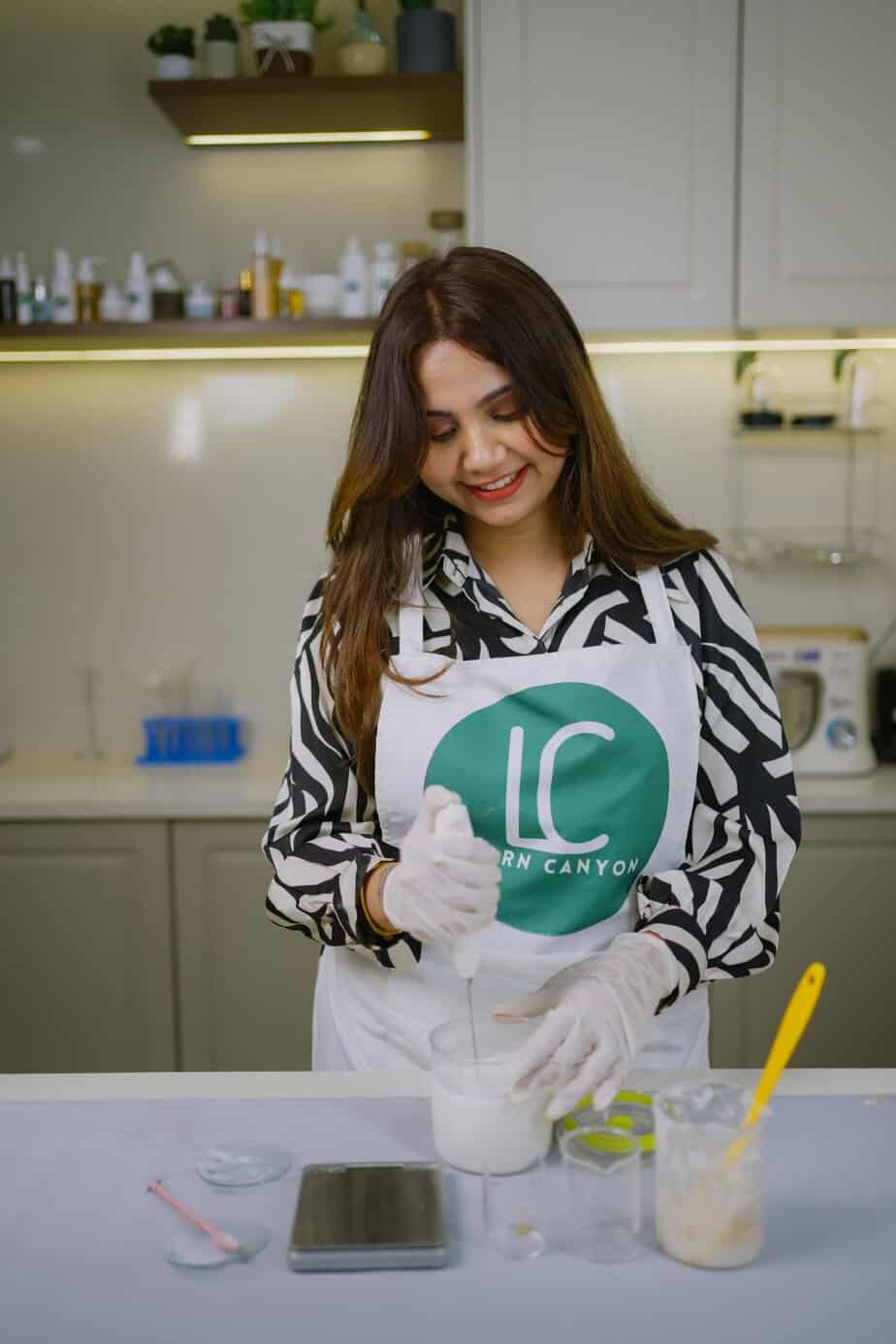 Professional portrait of Priya, founder, in the formulation lab